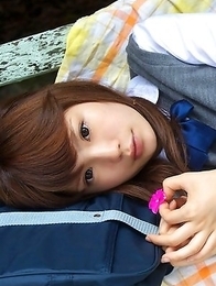 Manami Sato in short uniform skirt spends time in the park