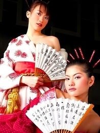 Mona Choi and Mind Sumonrat are dressed up as royalty as they hold their fans in their hands. Mona Choi and Mind Sumonrat are dressed up as royalty as they hold their fans in their hands.