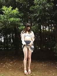 Riko Tabe shows boobs and trimmed pussy under skirt in a park.