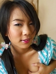 Dolla Dolaya lies on her stomach and gives that nice innocent smile.