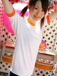 Naoko Sawano in sports outfit plays with balls in garden