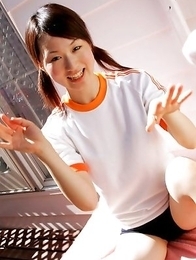 Naoko Sawano in sports outfit plays with balls in garden